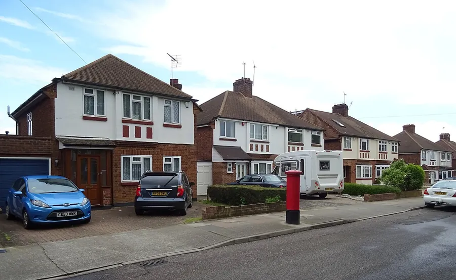 Semi-detached houses on Lichfield Terrace in Upminster with block paved front driveways and cars parked on them