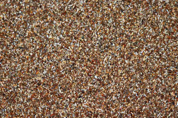 Close-up of a resin bound driveway surface showing small rounded stones held in clear resin