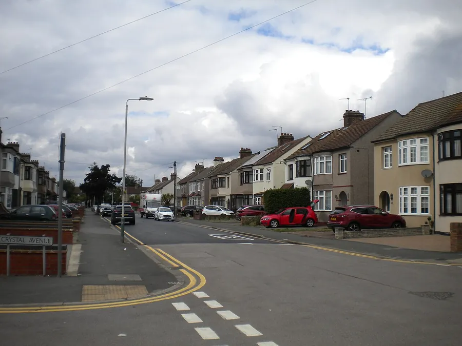 Street of 1930s semi-detached houses on Standen Avenue in Hornchurch with cars parked on front driveways