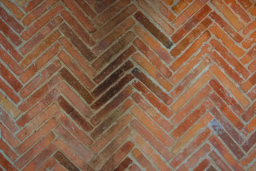 Close-up of herringbone block paving showing the interlocking pattern and sanded joints