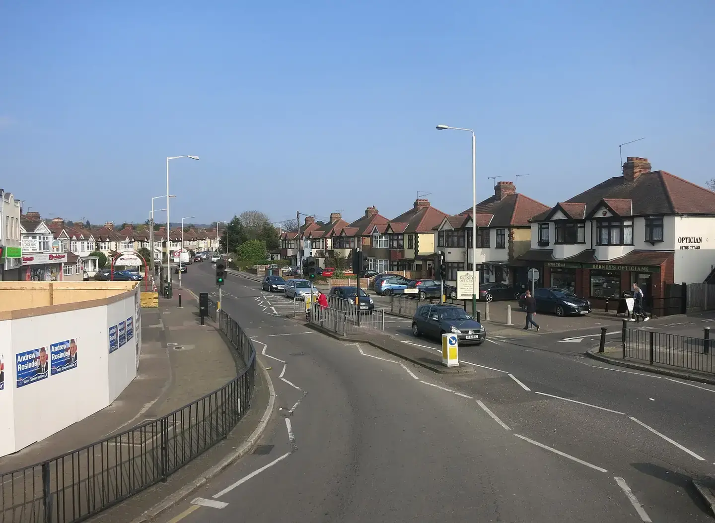 Nineteen-thirties semi-detached houses with bay windows and paved front gardens on a residential street in Collier Row, Romford